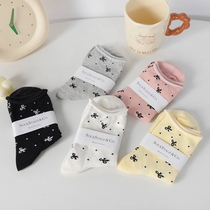 Five pairs of cotton polka dot socks with bows in black, grey, white, pink and yellow