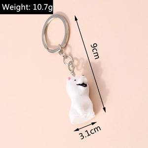 Detail view of cartoon dog keychain with size 9cm by 3.1cm and weight specifications