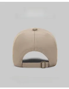 Detail of adjustable metal buckle strap on a cotton baseball cap in khaki and multiple colors