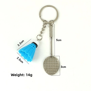 Detail view of badminton keychain featuring blue shuttlecock and silver metal racket specs