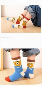 Detail of soft combed cotton crew socks with tiger patterns and vibrant contrast colors