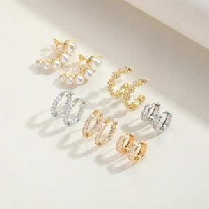 Detail view of 6-pair earring set featuring gold hoops, pearls, and zircon studs