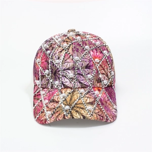 Close-up of floral baseball cap featuring sparkling silver rhinestones and white pearls