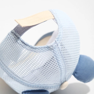 Detail of breathable mesh fabric and adjustable velcro strap on toddler sun hat