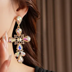Vintage gold cross earrings with AB crystal rhinestones shown on model for a retro look