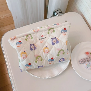 Quilted floral makeup bag with cute cartoon prints and zipper closure in cream white
