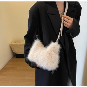 Close-up of plush faux fur crossbody bag in beige with sleek silver metal buckle