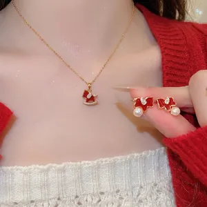 Gold plated rocking horse jewelry set with red enamel pendant and pearl earrings