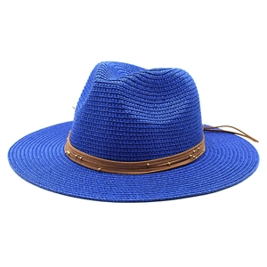 Detail of royal blue woven fedora straw hat with brown leather cords and gold beads