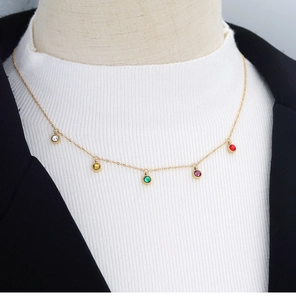 Detail of 18K gold necklace with five colorful round zircon pendants on a mannequin