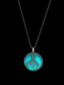 Glow-in-the-dark giraffe pendant necklace featuring turquoise luminous circular charm