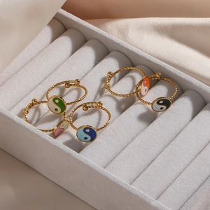 Set of four 18K gold plated Yin Yang rings with colorful enamel finishes in a jewelry box