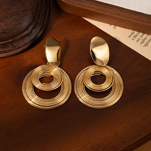 Elegant gold titanium geometric earrings with spiral hoop design and polished metal finish