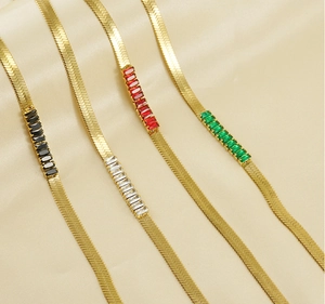 Flat snake bone necklaces in 18K gold finish with black white red and green zircons