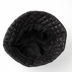 Detail view of black quilted puffer bucket hat showing inner lining and adjustable drawstring