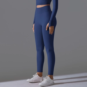 Detail of navy seamless high waist leggings and long sleeve crop top with thumbholes