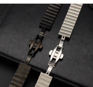 Detailed shot of black and silver stainless steel watch bands with butterfly buckles