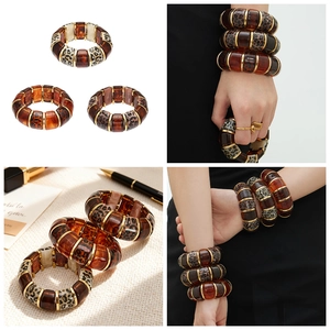 Detail view of leopard resin bracelet with 18k gold-plated accents and elastic band