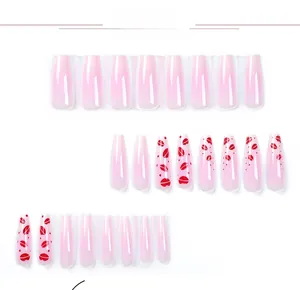 Detailed view of long ballerina press-on nails with pink gradient and red lip patterns