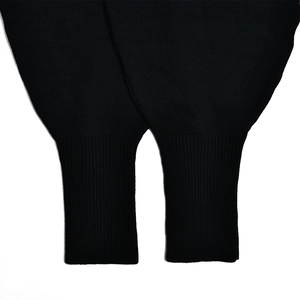 Close-up of black knitted ribbed cuffs on two-piece winter lounge set for women
