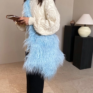 Chic light blue plush shoulder bag shown from a side view on a model for a trendy look