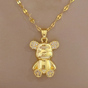 Macro view of gold teddy bear pendant featuring shimmering rhinestones and metallic luster