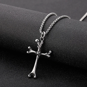 Silver stainless steel cross bone pendant necklace with box chain on dark background