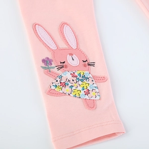 Close-up of pink cotton leggings for girls with cute embroidered rabbit and soft knit texture