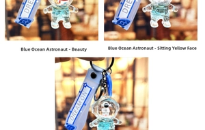 Detail of blue astronaut liquid quicksand keychain with Dream On silicone strap and astronaut toy