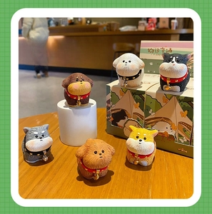 Detailed close-up of six resin puppy figurines with realistic fur texture and tiny bells