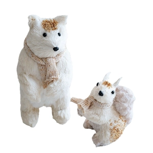 White and gold Christmas table decor featuring glittery bear and squirrel with knit scarves