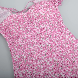 Close-up of pink floral pattern and bustier neckline on a summer maxi dress