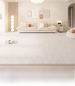 Close-up of cream-colored rug with fine woven texture and modern minimalist design
