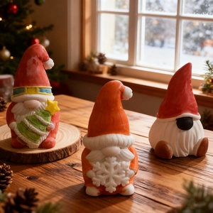 Three Christmas gnome ceramic figurines set with tree and snowflake patterns on a cozy winter background