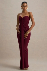 Detail view of burgundy strapless dress featuring elegant pleated texture and draped design