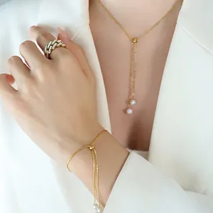 Elegant gold pearl jewelry set including tassel necklace, bracelet and geometric ring