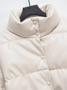 Detail of cream faux leather jacket showing stand collar and snap button closure