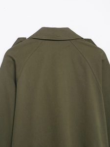 Close-up of the double-stitched back collar and shoulder on a military green trench coat