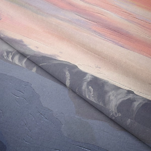 Close-up detail of soft bohemian tapestry featuring abstract mountain gradient texture
