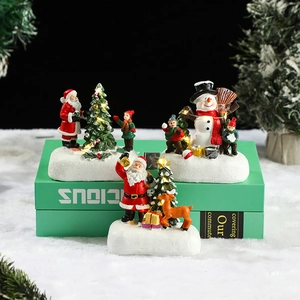 Lighted Christmas resin village set with Santa and snowman on books backdrop