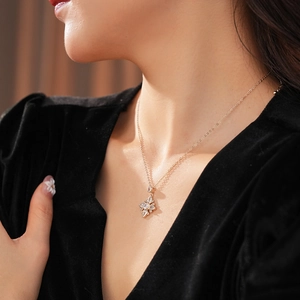 Close-up of rose gold flower pendant necklace with zircon crystals on model neck