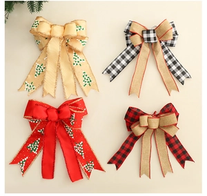 Detail of four festive Christmas plaid bows with glitter edges for holiday tree decor
