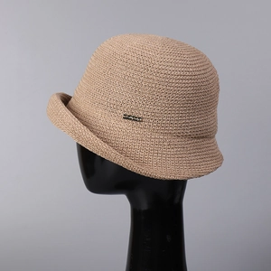 Breathable beige linen knit bucket hat with a stylish rolled brim and metal side label
