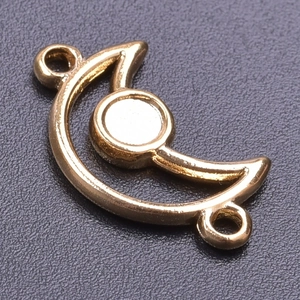 Macro shot of 18k gold plated moon pendant with blank circular gemstone tray