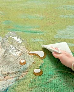 Detail showing waterproof oil painting style round rug with liquid droplets on surface