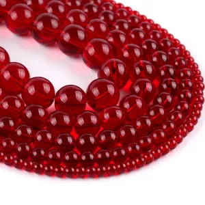 Macro shot of assorted sizes red translucent round stone beads for jewelry making