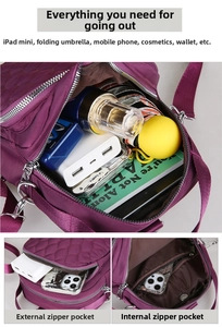 Detail view of purple quilted nylon bag showing multi-compartment storage and interior pockets