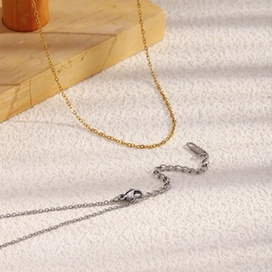 Detail of 1.4mm gold and silver stainless steel cross chains with lobster clasps