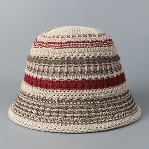 Detailed knit texture of a hollow striped bucket hat in beige, burgundy, and brown tones