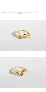 Detail shot of a polished gold-plated wavy ring with irregular geometric design